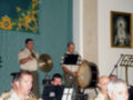 Banda militar tocando instrumentos tradicionales en un evento formal.