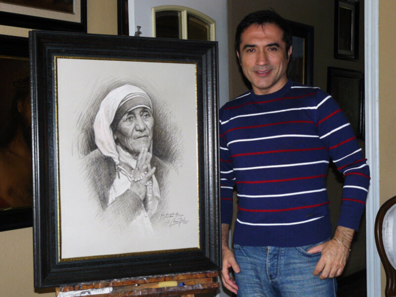Artista junto a su retrato en lápiz de una mujer con pañuelo en la cabeza.