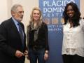 Personajes destacados posan junto a un cartel del Festival Plácido Domingo en Andalucía.