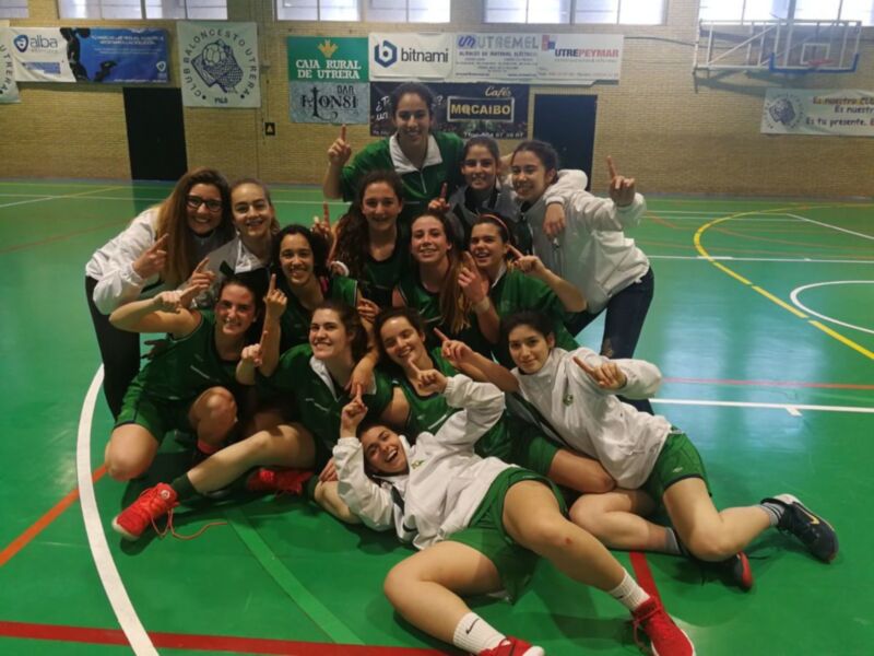 Estudiantes de fútbol femenino posan en el campo de juego, mostrando gestos de victoria.