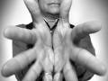Man with multiple hands, black and white photo.