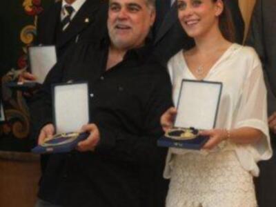 María león muy junto a su madre recoge la medalla de Sevilla para su hermano Paco León