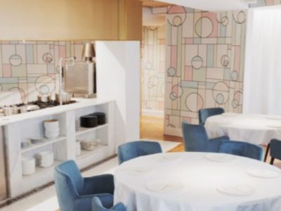 Salón moderno con mesas redondas, sillas azules y paredes decoradas con patrones geométricos.